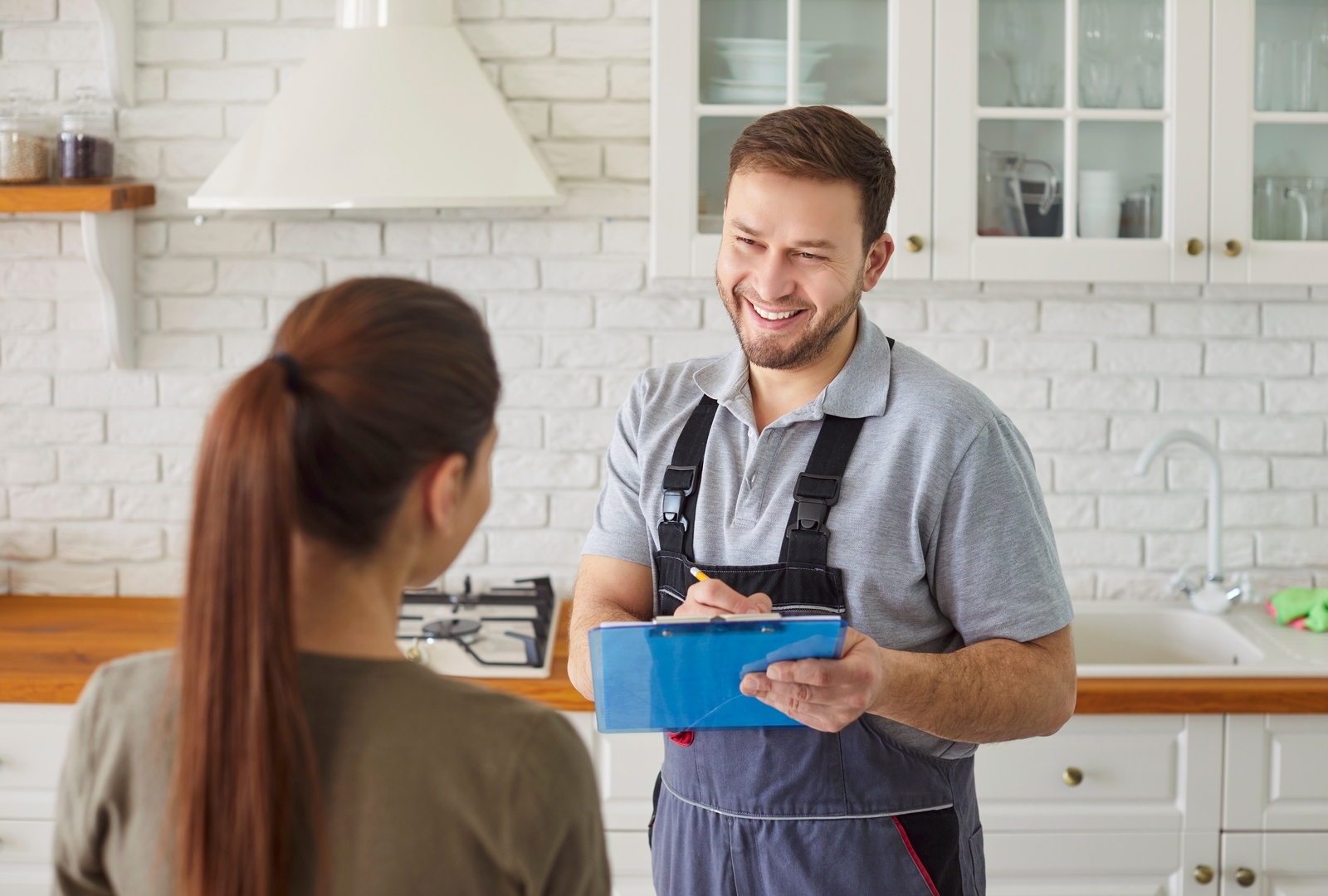 Manplumbertalkingwithfemaleclientsigningcontractforplumbing | construction spike Manplumbertalkingwithfemaleclientsigningcontractforplumbing