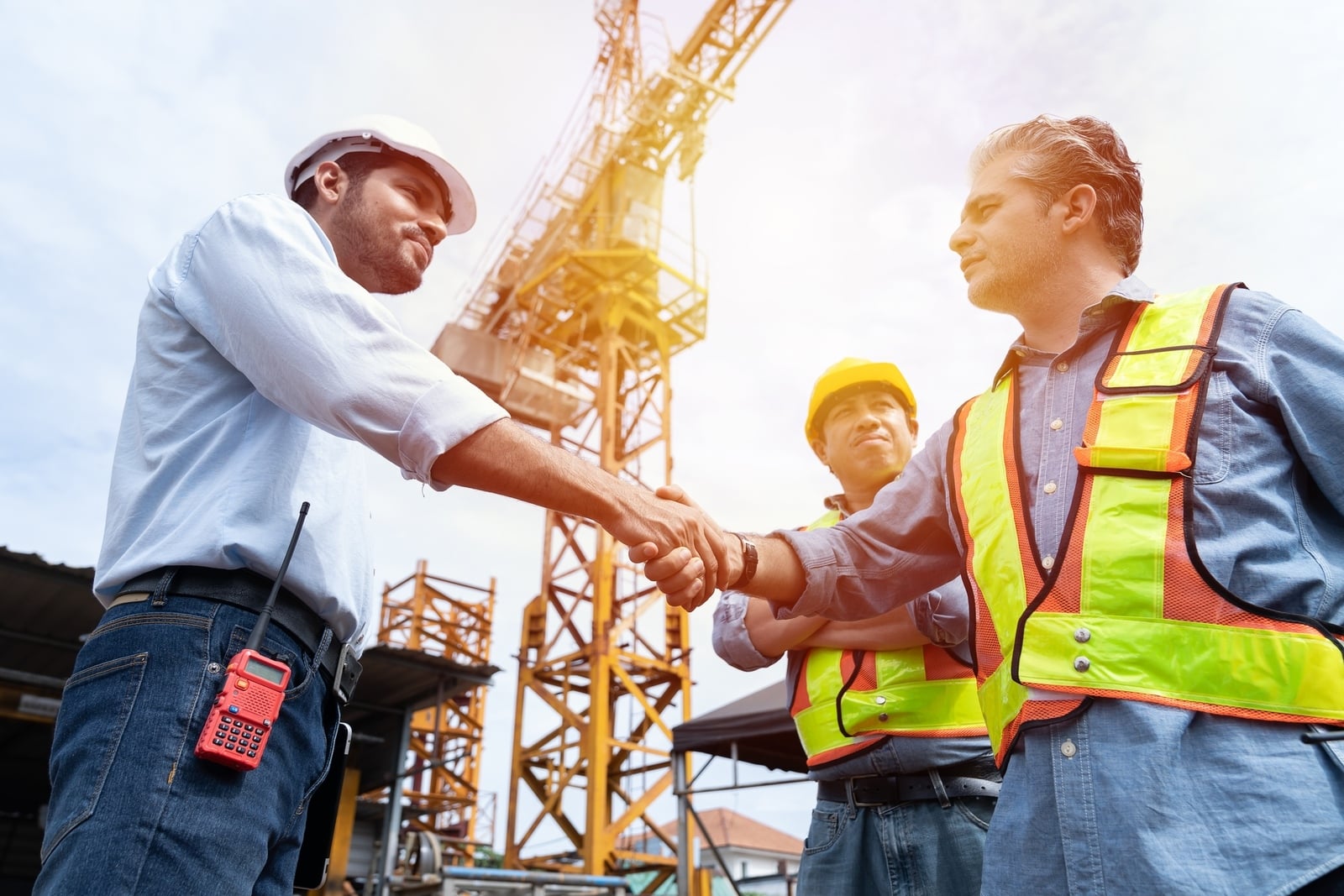 Groupofmaleengineerconstructionputtingtheirhandstogetherat