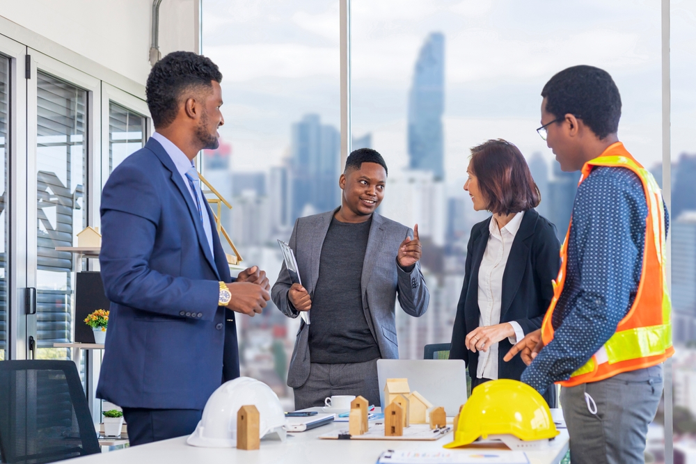 Africanamericanmanagerisdiscussingtohiscolleaguesinthe | construction spike Africanamericanmanagerisdiscussingtohiscolleaguesinthe