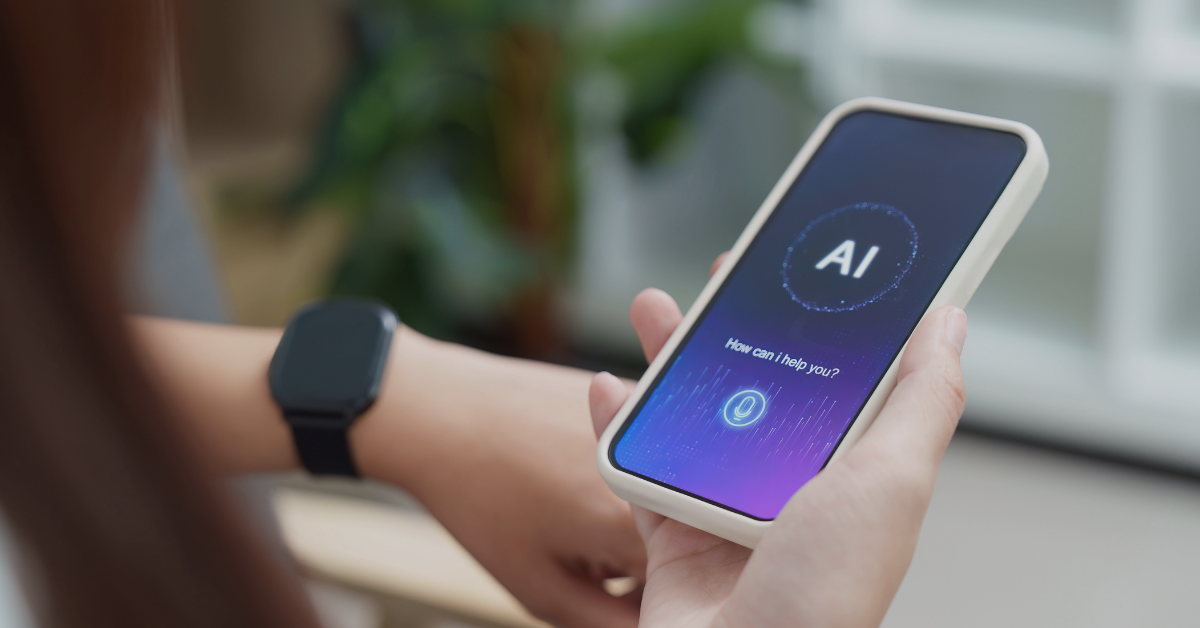 constructionspike-pressrelease Person holding a white smartphone displaying an AI assistant screen with 'How can I help you?' message.